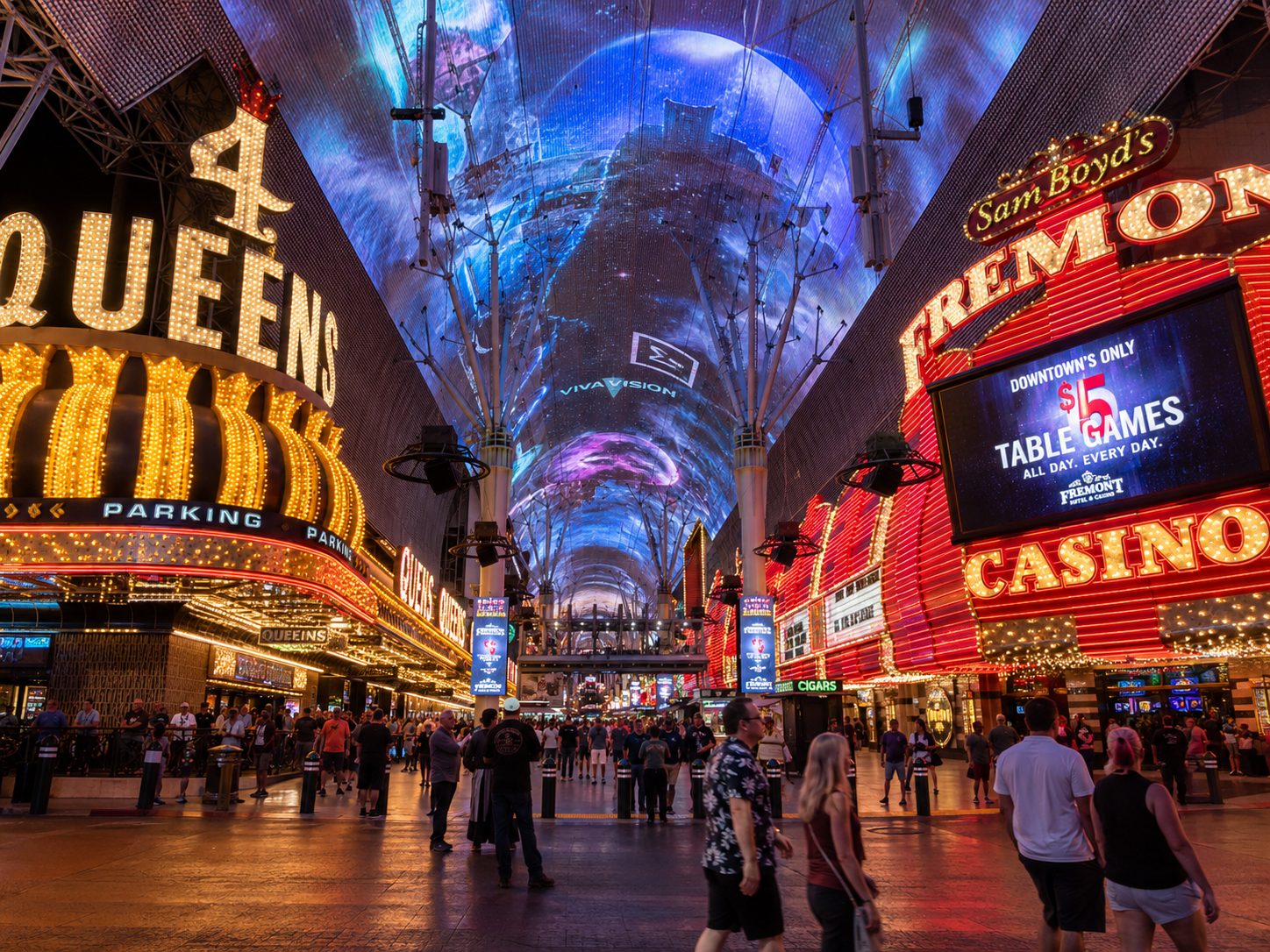 Fremont Street Experience canopy lit with neon casino signs and an overhead video screen